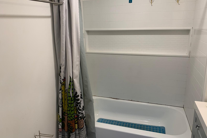 Private bathroom with sink, commode, shower and tub. - Furnished Basement Apartment