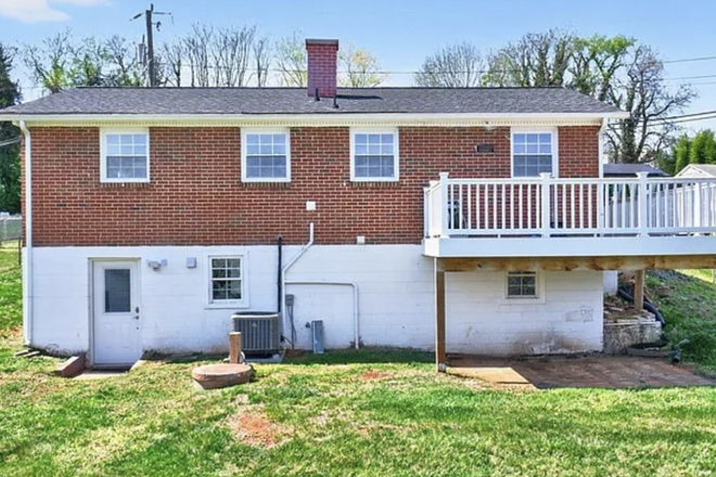Rear view with unit entrance - Private basement apartment, pet friendly with great backyard!