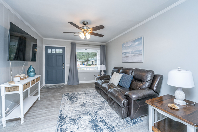 Living room - 55 in. SMART TV, reclining leather couch, 2 end tables with USB charging ports, ceiling fan - James Island home close to downtown Charleston