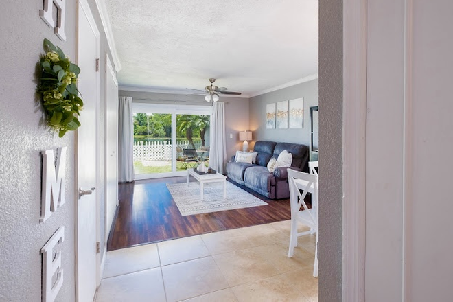 Living room and dining room, view of outdoors - Condo w/ Private yard and water view