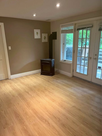 Living room with walkout and porch - Spacious One bedroom Basement Apartment (Steps from TTC Line 1)