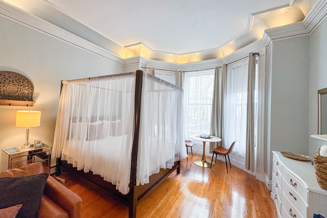 Bay Windows next to bed are great for getting light into the unit. - BEA3372 Oversized Studio Boston Brownstone Back Bay Apartments