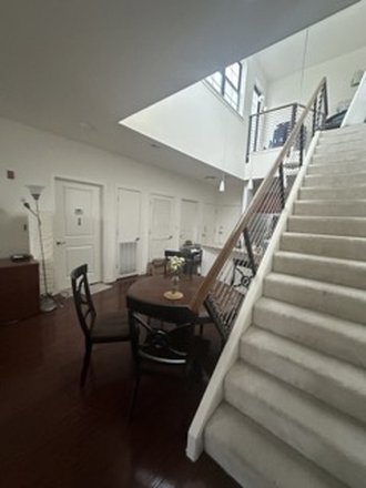Living area and kitchen, stairs to private rooftop - Subletting Village Lofts Apartment