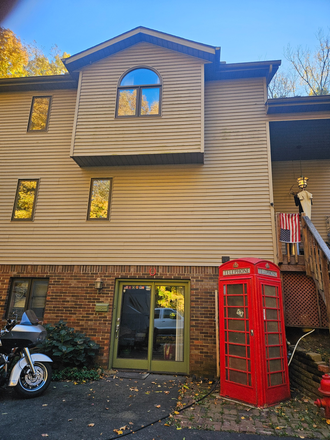 Front entrance to finished walkout basement with authentic British Phone Booth from Walkden {Manchester} for all you Man U fans - Private Furnished Country Home Within the City