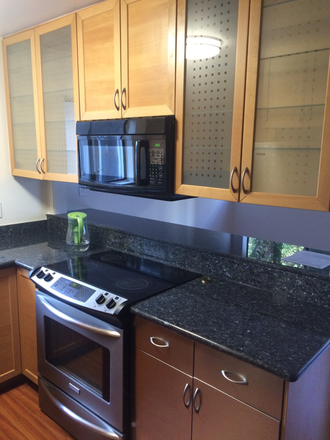 kitchen - Furnished private room available in a 3-bed/3-full-bath condo inside a secured, off-street building.