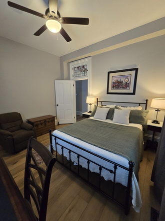 Bedroom 1 - Equipped with queen bed, nightstands, desk, and chair. - Fully Furnished 2 Bed/1 Bath with Utilities Included Duplex