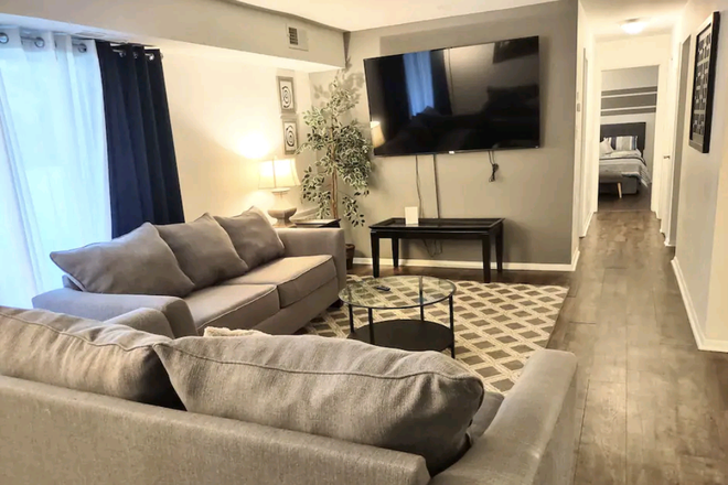 Living room with 70" TV with Roku - Cozy Condo in Raleigh