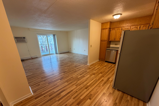 Visit hubrealtyproperties.com - Bright front facing 2 bedroom, walk to the T and campus