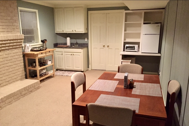Looking towards the entrance from den/bedroom into kitchen dining area. We now have a full size refrigerator. - Furnished basement apartment, private entrance
