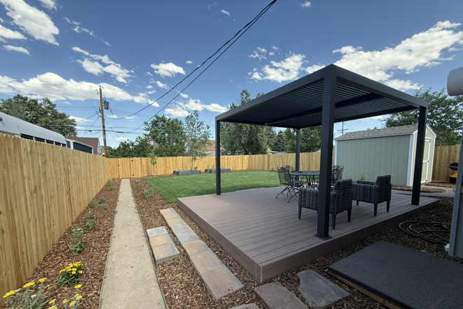Back deck - Cute house in North Park Hill: 4 bed 2 bath with laundry, AC/heat, and a big backyard.