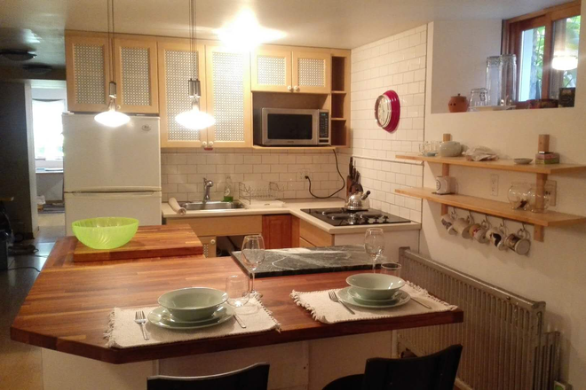 kitchen with butcher block island - Spacious 1 Bedroom Apartment + Den/Second Bedroom - 5 Minute Walk to Campus!