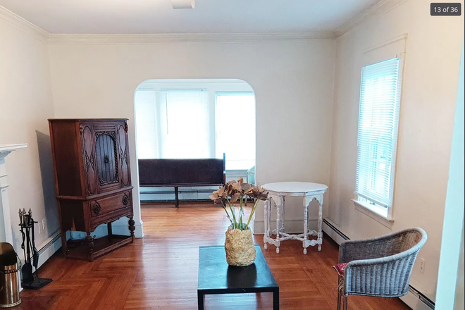 Living room with view of side open room area in the back. - Large 2 bedroom apartment, 1st floor, East Side. Big windows. Working fireplace, hardwoods & more