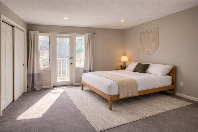 Main Bedroom with large closets, working area and private  balcony - Furnished 2BR | West Cambridge/Fresh Pond | Easy Harvard Access | All-Inclusive | Pet-Friendly Townhome