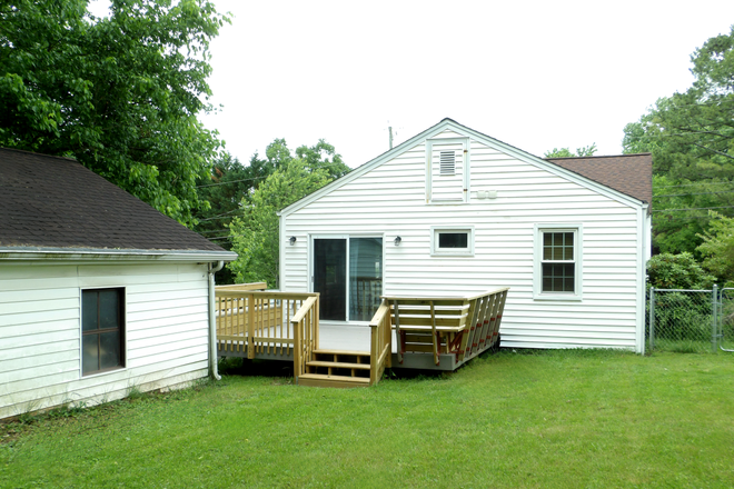 Detached garage view w/ back deck. Deck has built-in seating - Cute Single Family 3-Bedroom / 2-Bath Home, 2.9 Mile from Campus