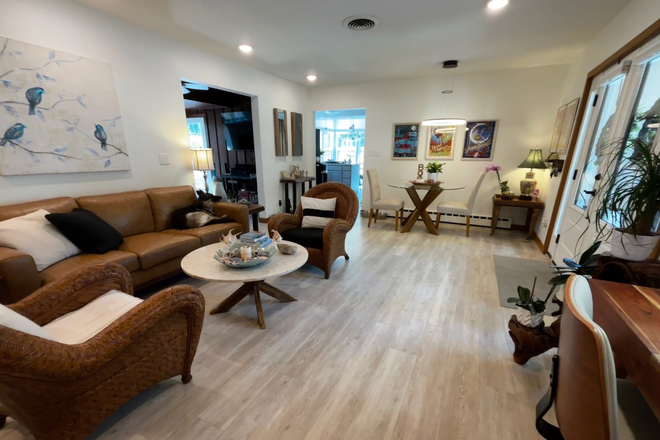 living room looking through to dining and kitchen - Modern 1-Level Executive Home Walking Distance to UIHC and campus w/ large fenced yard