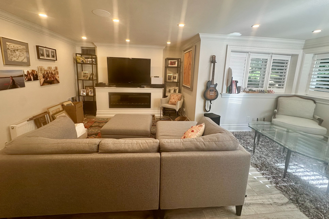 Livingroom with TV and Fireplace (electric) - Bright, Spacious, Furnished & All-inclusive 1-Bedroom Suite — Steps to Yonge & Eglinton Subway House