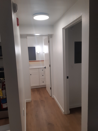 Corridor to the bedroom on the right and bathroom at the end - Sublet unit at Parkview Apartments - Near downtown