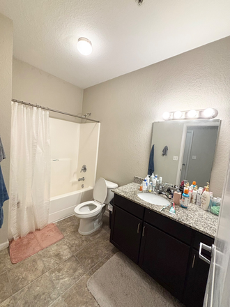 Bathroom (attached to bedroom) with towel holders on the left, AC, and several cabinets - Lark Chapel Hill, Apartment Close to Campus