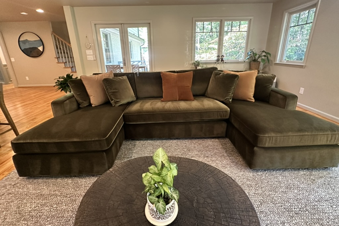 The Great Room, vaulted ceilings & expansive windows offer views over an acre of forest & a creek tributary. Natural light fills the space. - Woodland Forest - Upscale 6 bedroom Home in East Chapel Hill