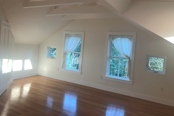 Main Room, windows face downtown and sunsets - Modern 1 Bedroom in a Victorian building Apartments
