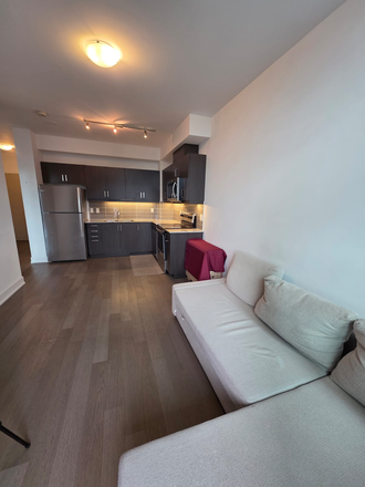 LIVING ROOM FROM BALCONY - 1 Bedroom + Den Semi Furnished Condo With Parking on same level at The Barrington