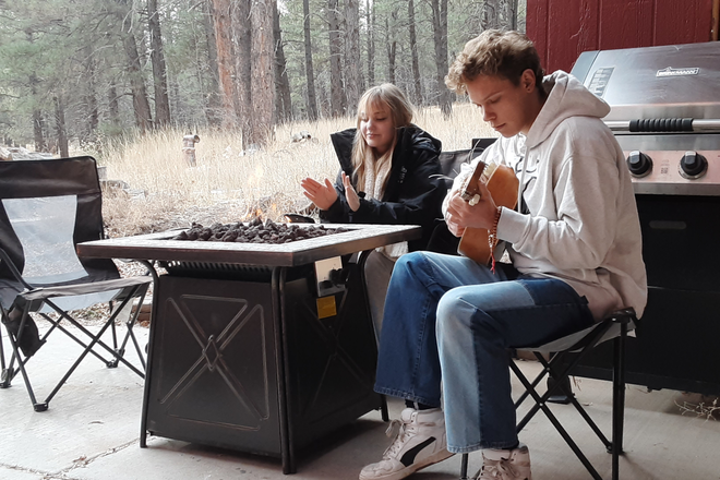Outside front, with gas firepit, forest in background - Furnished Two bedroom apartment. Private, Quiet, next to Forest. Utilities included. EV charge