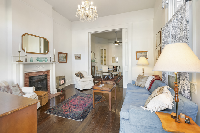 Living room seating, chandelier, pocket doors - Furnished Garden District 2 bedroom, 1 bath apt