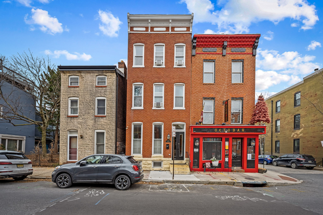 exterior front (red brick three stories) - Spacious Five-Bedroom, 4.5 Baths Federal Hill Rental with Roof Deck Townhome