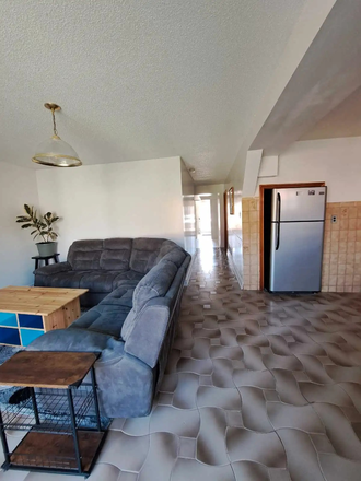 partial view of living room, kitchen, and hallway to main entrance near street / driveway - One-bedroom furnished walk-out basement apartment near Downsview Park Station in Glenfield
