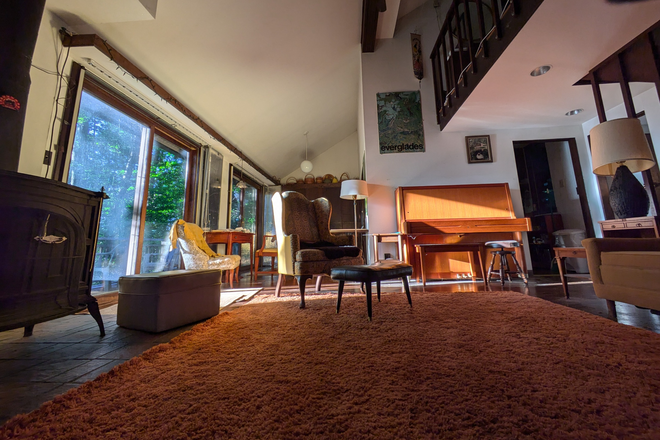 Living Room wide angle view towards dining nook - Furnished 3 Bedroom Mid-Century Modern House in Nature overlooking Puffer's Pond