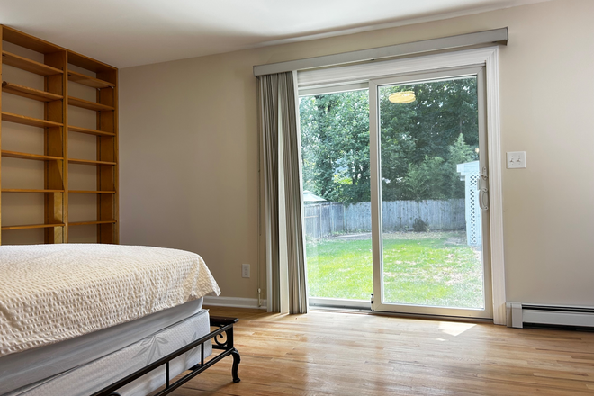Slider door to the backyard - Furnished primary bedroom in shared home-Erdman Ave-Princeton