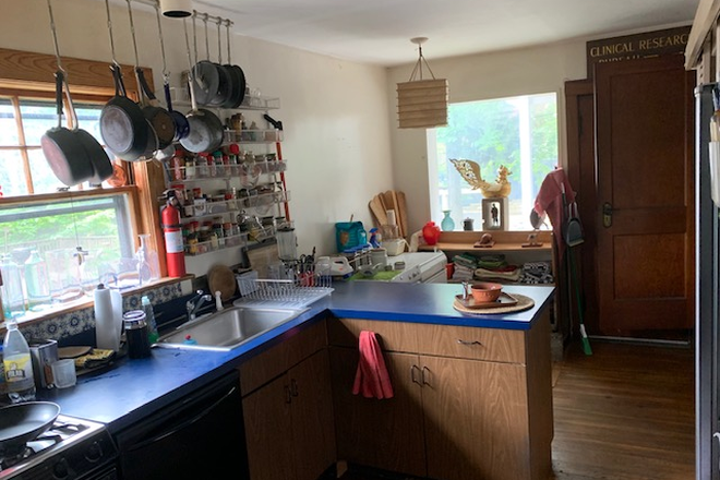 Kitchen with many pots and pans and cooking items - Close by Porter Sq. lovely room for rent 1/15/26-5/15/26. Duplex