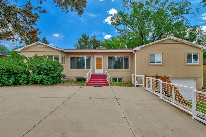 Home with concrete patio and attached garage, plus detached garage and carport - Walk to UCCS!