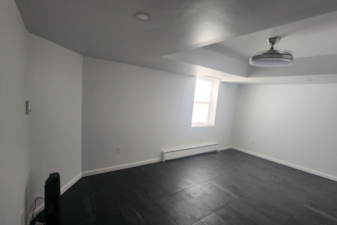 Bed/Living area.  Baseboard heater and portable AC included. - Newly-renovated Basement studio with full-sized windows in SFH; 1 mile to CUA House