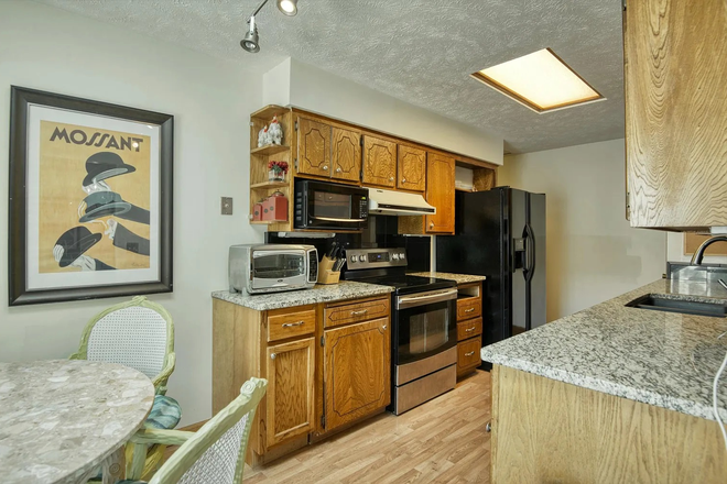 Kitchen with new stove - Located in Omaha 10 min from UNO and 15 Min from Creighton just off I-80 Very easy access to I-80 Duplex