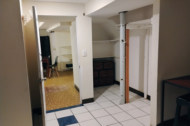 Bedroom from edge of bed facing doorway - kitchen and living space on other side - Basement Apartment in Hollywood Neighborhood