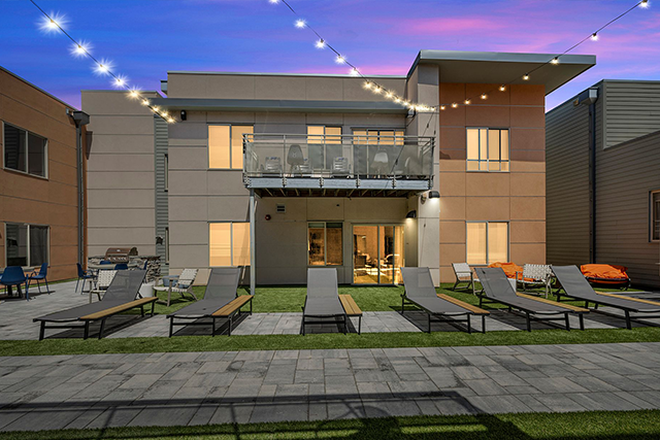 Courtyard with Grills, tanning chairs and more! - SAGA Apartment Complex