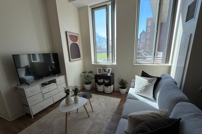 Living room with garden view - Amazing Fully Furnished 1-Bedroom in OWA (HBS Campus) Apartments