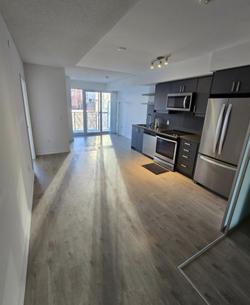 Living & dining room + balcony - 1 Furnished Master Bedroom Right by Wellesley TTC Station [JULY SUBLET]
