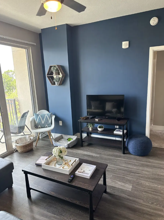 Furnished living room (coffee table, TV) - The Standard Apartments