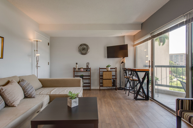 Living room with large slider to balcony - One block from Vanderbilt. Fully furnished, 1-BR, 1-BA, condo