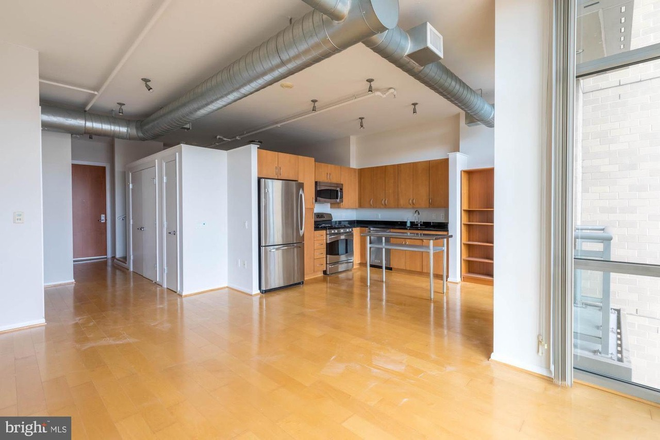 Kitchen/Living - Madrigal Lofts apartment offers a convenient location and great amenities