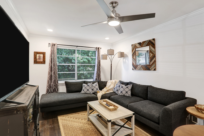 Comfortable living room with smart TV - Stylish newly renovated furnished condo w/ pool for visiting professionals/students-Emory/Decatur