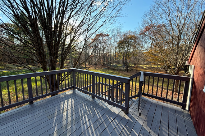 Main entrance stairs from deck. View of pond on property. - Charming Furnished Apartment on Quiet Country Estate