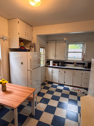 Pretty kitchen with ample cupboard space and newer appliances. - Beautiful Victorian home directly across from campus