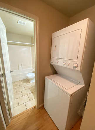 Washer and Dryer with bathroom in background - 449 North Donahue Drive Auburn, AL 36832 Apartments